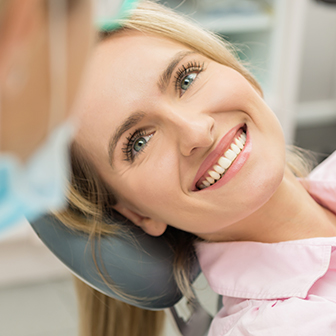 smiling woman sitting in dental chair