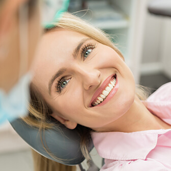 smiling woman sitting in a dental chair