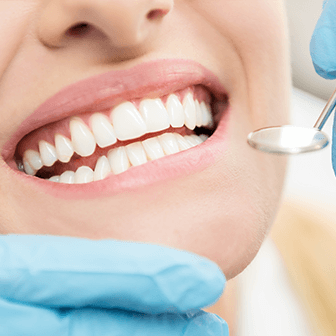 closeup of teeth being examined with a mirror